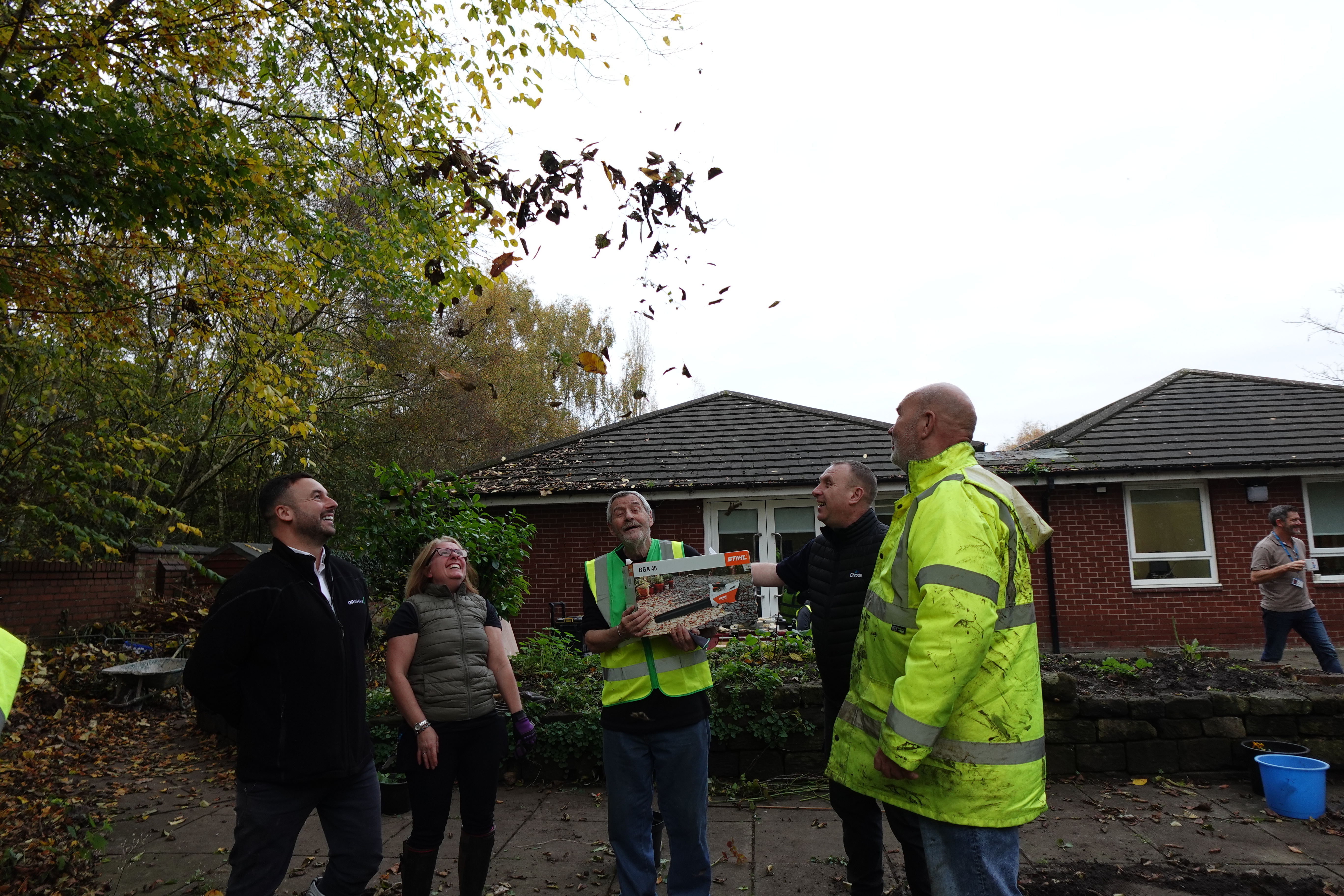 Tom, groundsman volunteer, receiving his leaf blower